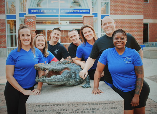 USM staff with gator statue at UF