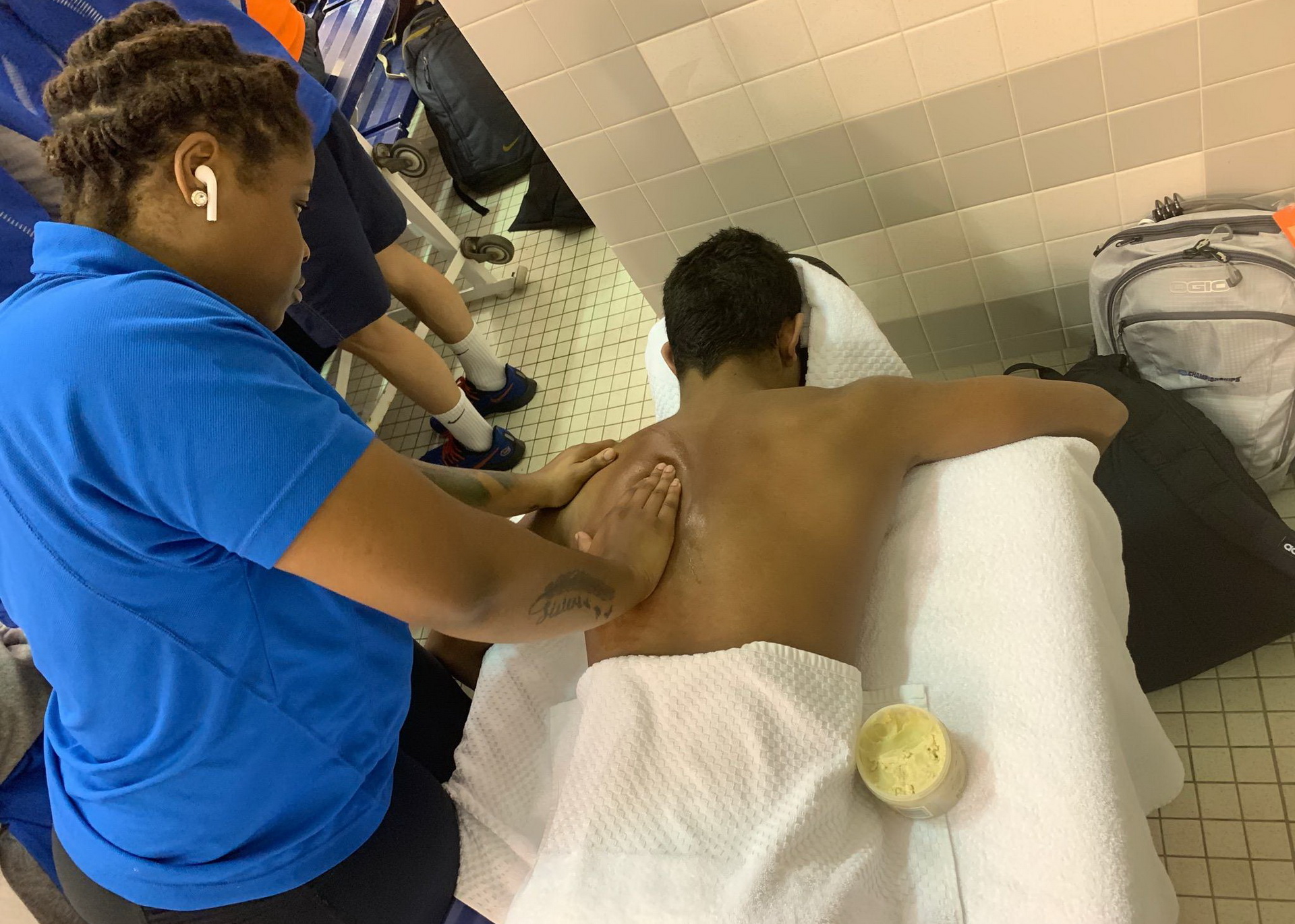 athlete receiving sports massage in locker room